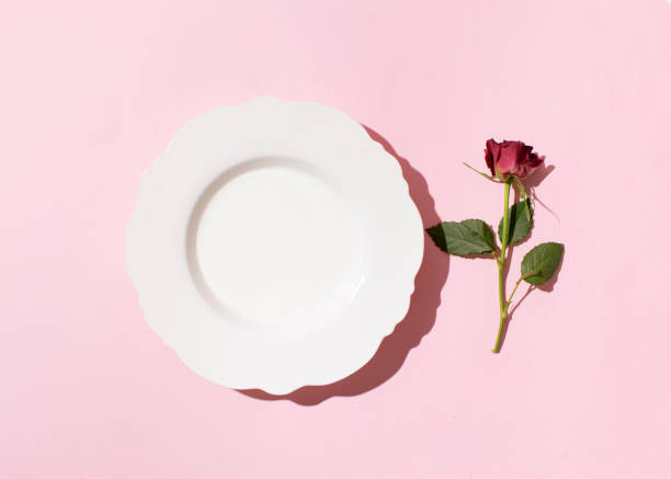 istock Elegant white soup with a crimson rose flower 2203495449
