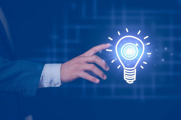 istock Businessman pointing at virtual light bulb in concept of idea technology science and artificial intelligence, innovation futuristic and global connection business and new tech ideas 2203496137