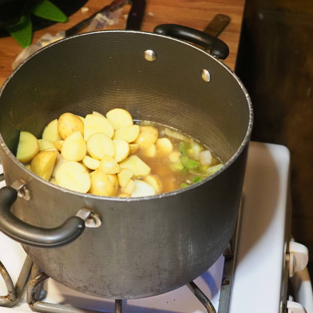 istock potatoes in a black cooking pot 2203496527