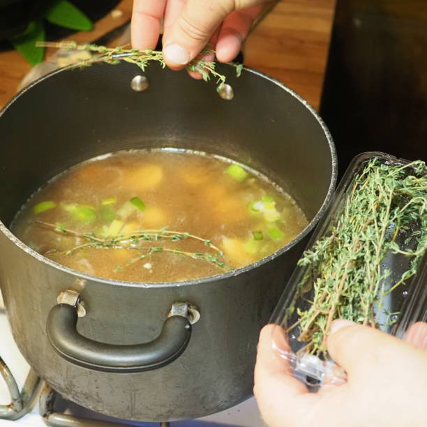 istock Adding thyme to a pot of soup 2203496686