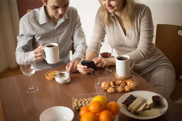 istock A Couple Enjoying Coffee and Snacks Together at a Table in a Cozy Setting 2203498905