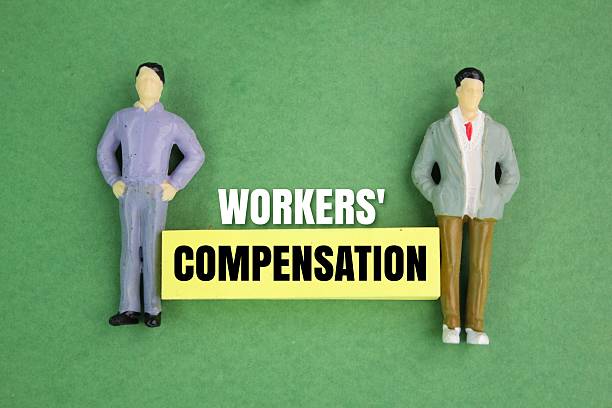 istock miniature people and paper with the word workers' compensation 2203501509