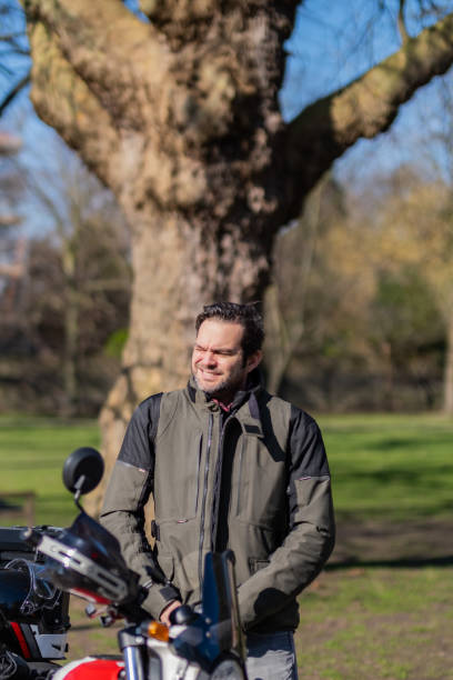 istock Young adult man wearing motorcycle jacket 2203505962