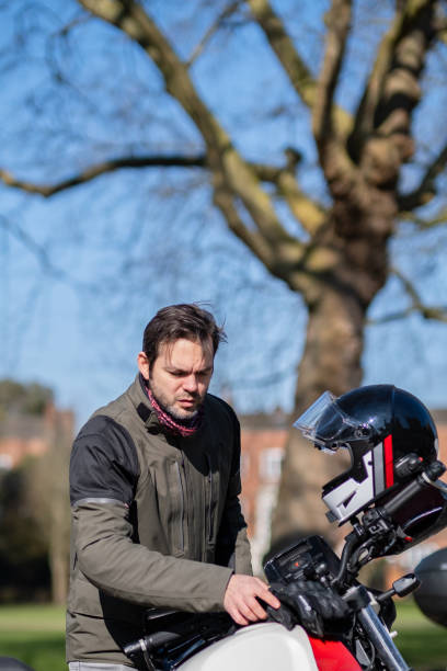 istock Man rider getting ready to ride his motorcycle 2203506132