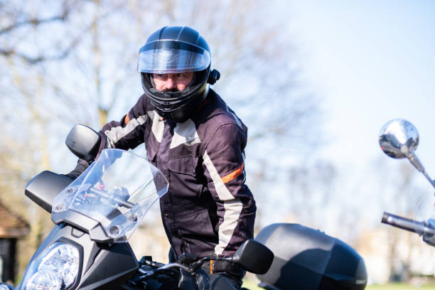 istock Male rider getting on his motorcycle 2203507020