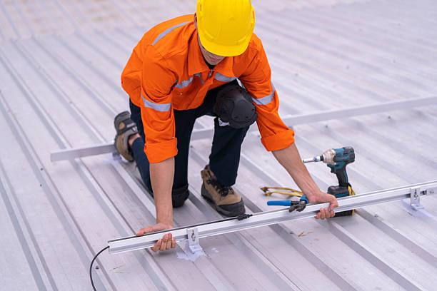 istock Technician in safety uniform and helmet kneeling on a rooftop, using a drill for precise installation work. A scene highlighting safety, professionalism, and technical expertise in construction. 2203507702