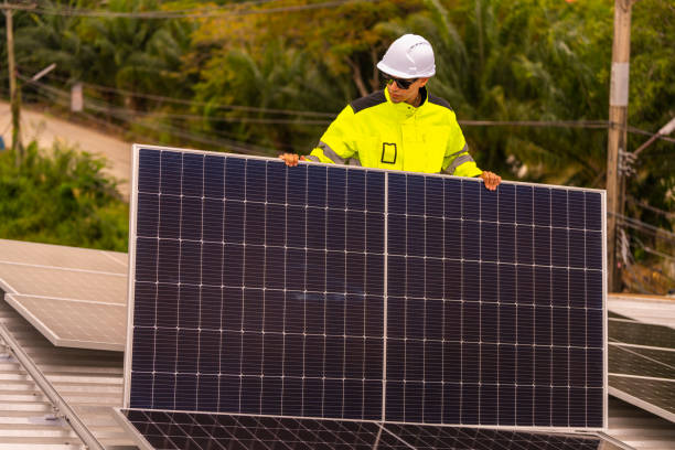 istock technician lifting a photovoltaic panel during installation, showcasing renewable energy advancement. Dressed in safety gear, reflecting a focus on green energy solutions and sustainable development. 2203507961