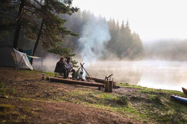 istock Couple enjoying each other by the campfire on a camping vacation. 2203510929
