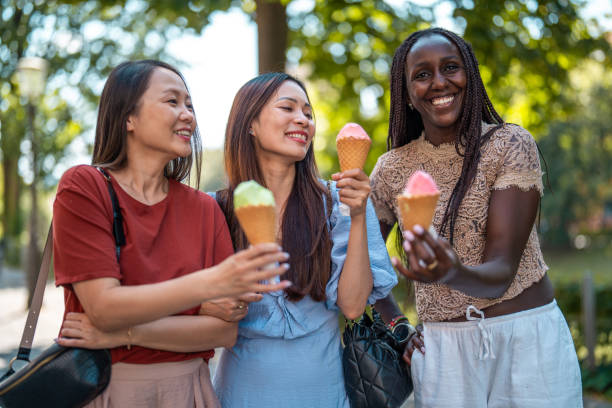 istock Diverse Women Sharing Ice Cream Moment 2203511825