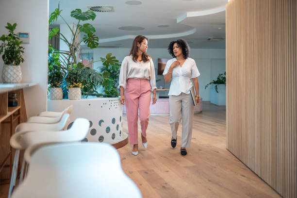 istock Diverse Businesswomen in Collaborative Stride at Modern Workplace 2203511828