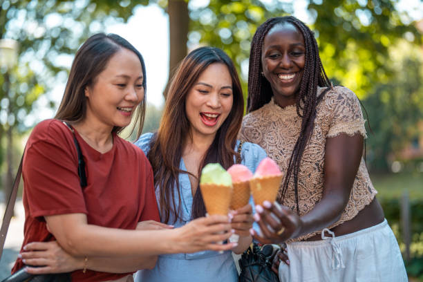 istock Diverse Friends Sharing Ice Cream Outdoors 2203511844