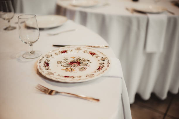 Antique floral dinner plate table setting at wedding reception