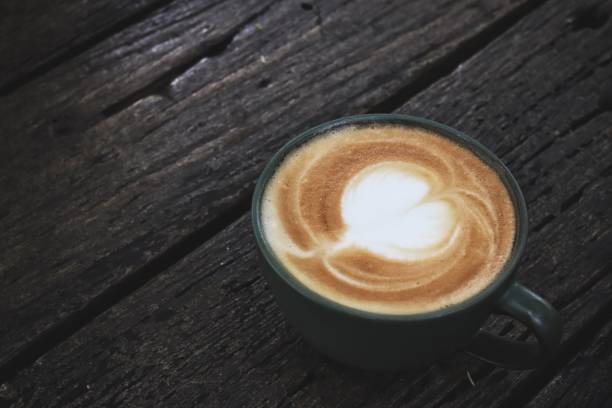 istock Latte art coffee cup on wooden table 2203517676