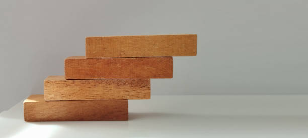 istock Wooden block stacking exercise minimalist studio photography indoor eye-level conceptual growth 2203518278