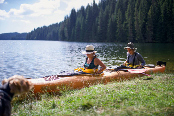 istock Two women having fun on kayaking journey in mountain lake. 2203520874