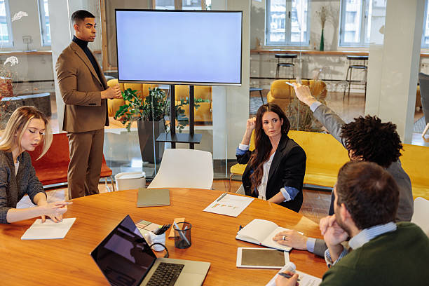istock Manager having a presentation while his employees are listening and working 2203522139