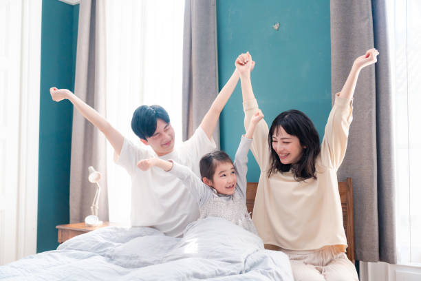 istock Families waking up well in bed 2203522175
