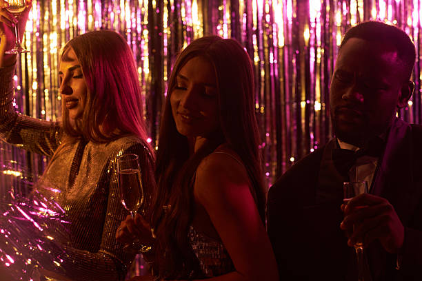istock Celebrating at Vibrant Party Holding Glasses 2203533394