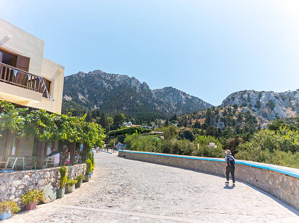 Zia Greece - August 25 2024; Stone cliffs rise sharly behind the highest town on Kos, Zia.