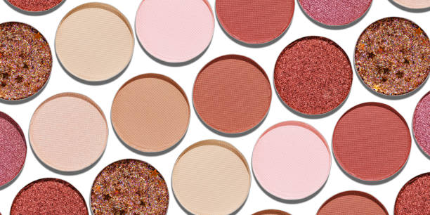 istock Colorful Swatches eyeshadow refills as minimal geometric pattern, banner. Matte, glitter pans red brown pink shade with shadows, detailed texture, cosmetic, beauty product, make up, warm color scheme 2203534404