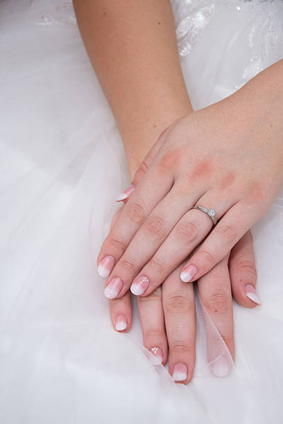 A woman is holding a ring in her hand, and it is a wedding ring. Concept of love and commitment, as the woman is holding the ring that symbolizes her relationship with her partner