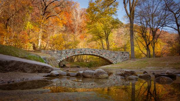 istock Pedestrian rock bridge over Peas Creek in Ledges State Park, Iowa, during fall 2203540322
