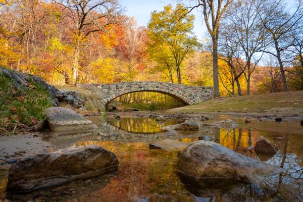 istock Pedestrian rock bridge over Peas Creek in Ledges State Park, Iowa, during fall 2203540352