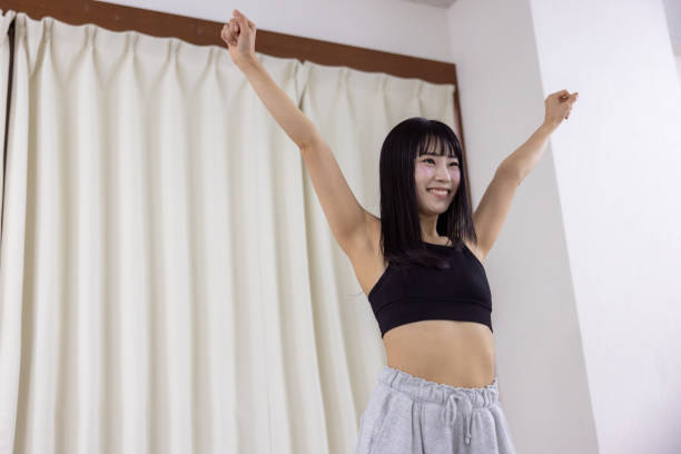 Female athlete dancing in dance studio - hand raised
