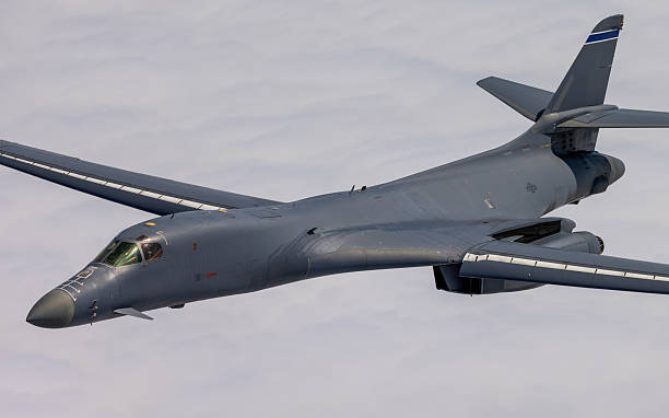 istock Very close side  view of a B-1 Lancer among clouds, with wings full forward 2203542610