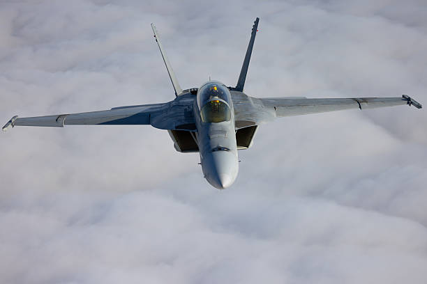 istock Frontal view of a F/A-18F Super Hornet  over clouds 2203542630