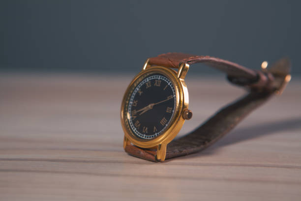 istock watch on wooden table, close up 2203545078