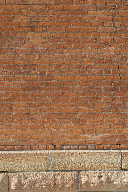 istock Grungy vintage orange color brick wall background 2203545808