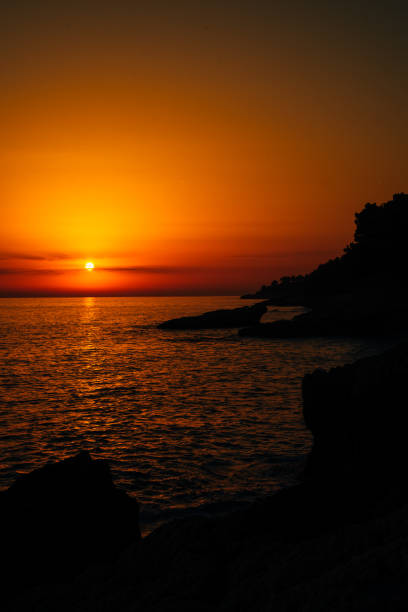 Red sunset over the sea on a rocky shore. High quality photo