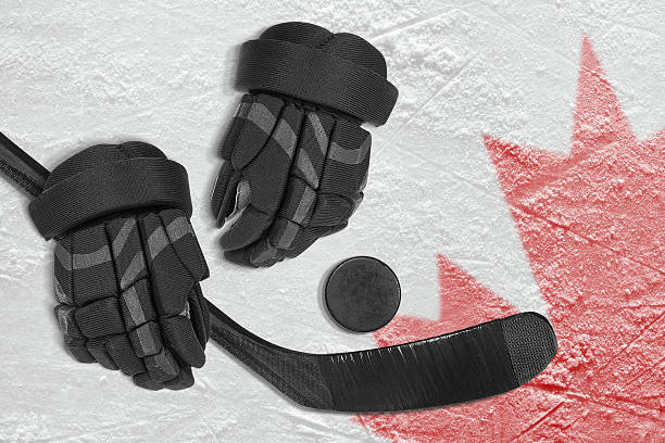 istock Hockey Accessories On Ice With Canadian Flag 2203549218