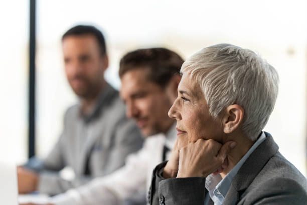 istock Smiling senior entrepreneur on a meeting in the office. 2203550190