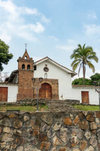 istock Colonial church with brick facade and palm trees. 2203551751
