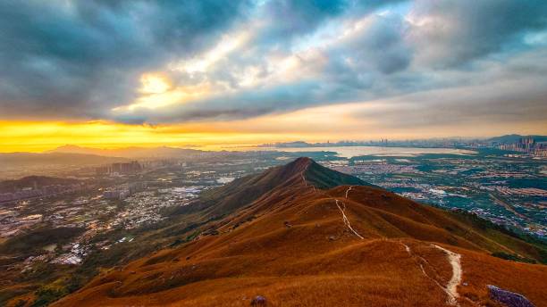 istock Mountain ridge at sunset with cityscape view. 2203553742