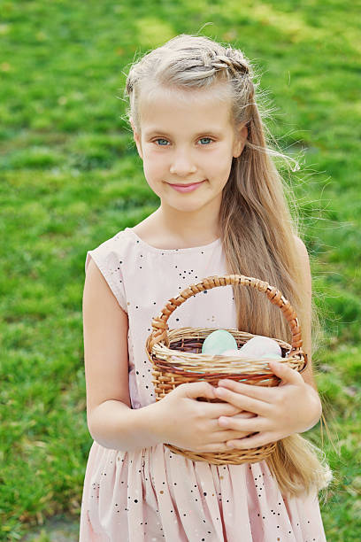 istock Happy Easter bunny. Child having fun outdoor. Kid playing with eggs and rabbit on green grass. Spring holidays concept. Easter Greeting Card Template. Easter baby girl with bunny and eggs 2203555838