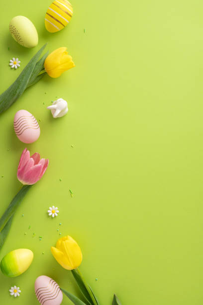 istock Seasonal vertical composition with tulips and decorative easter elements placed neatly over a green surface 2203556776