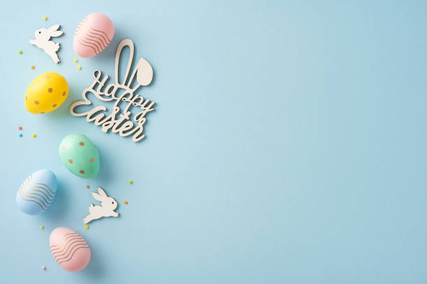 Easter-themed arrangement featuring decorative colored eggs and bunny shapes on a soft blue surface