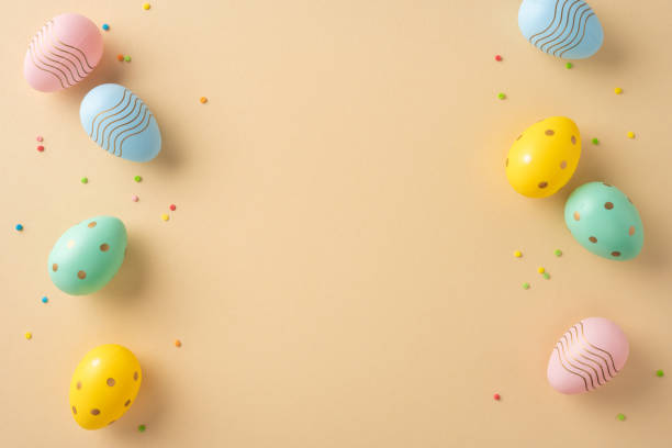istock Decorated Easter eggs in vibrant colors placed against a pastel background with sprinkles scattered. Perfect for festive designs or seasonal advertisements showcasing Easter themes and celebrations 2203556807