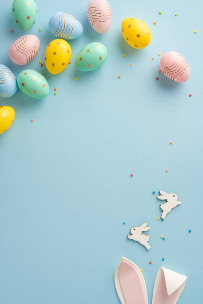 istock Flat lay vertical composition of colorful Easter eggs, bunnies, and accessories, creating a festive mood 2203556809