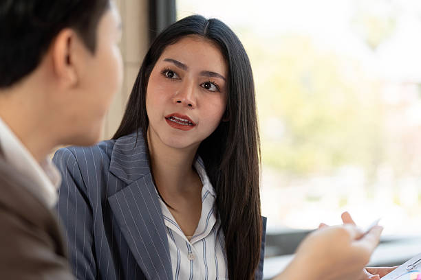 istock Focused conversation. A female professional discussing plans with her colleague. 2203557344