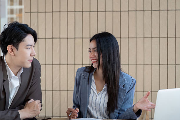 istock Professional collaboration. Two business professionals engaging in a discussion while analyzing project plans and strategies. 2203557376