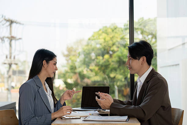 istock Collaboration in planning. Two professionals discussing project strategies in a modern workspace. 2203557696