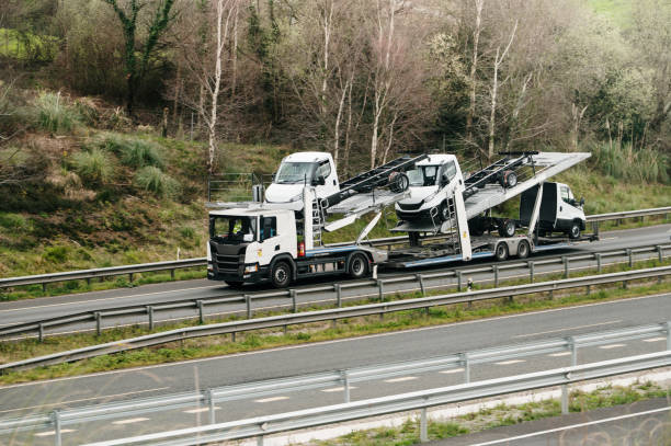istock Truck carrying smaller trucks 2203561116