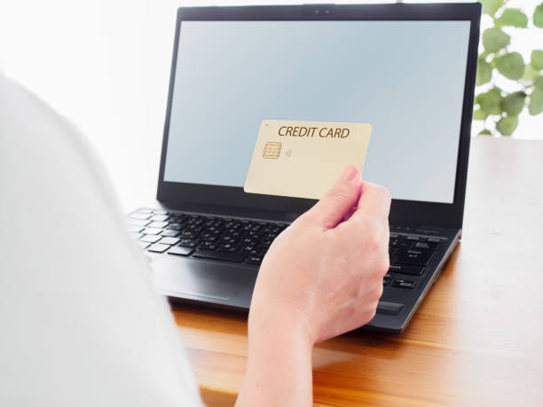 istock Woman using credit card with laptop 2203561399