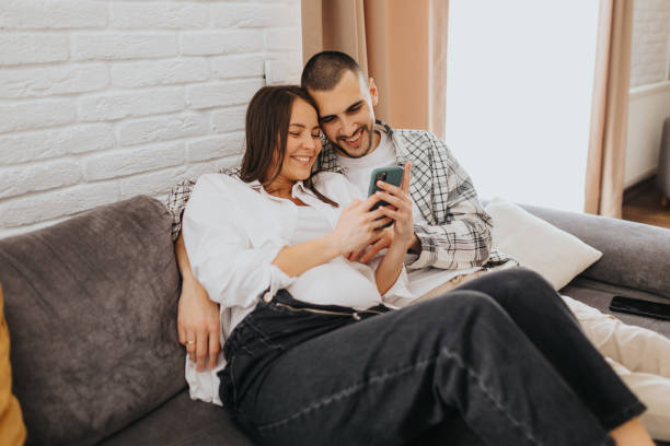 istock Happy young couple taking selfie at home 2203561910