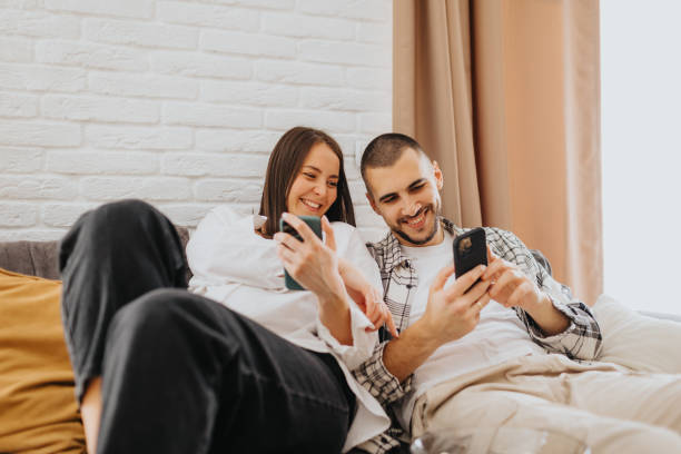 istock Happy young couple relaxing at home 2203562769