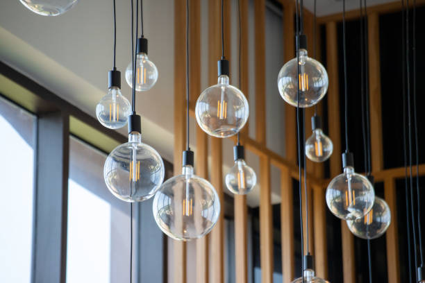istock A room with many light bulbs hanging from the ceiling 2203563154